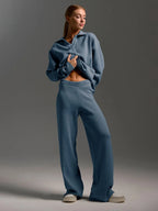 Full length shot showing the flowing silhouette of the grey knit set from behind