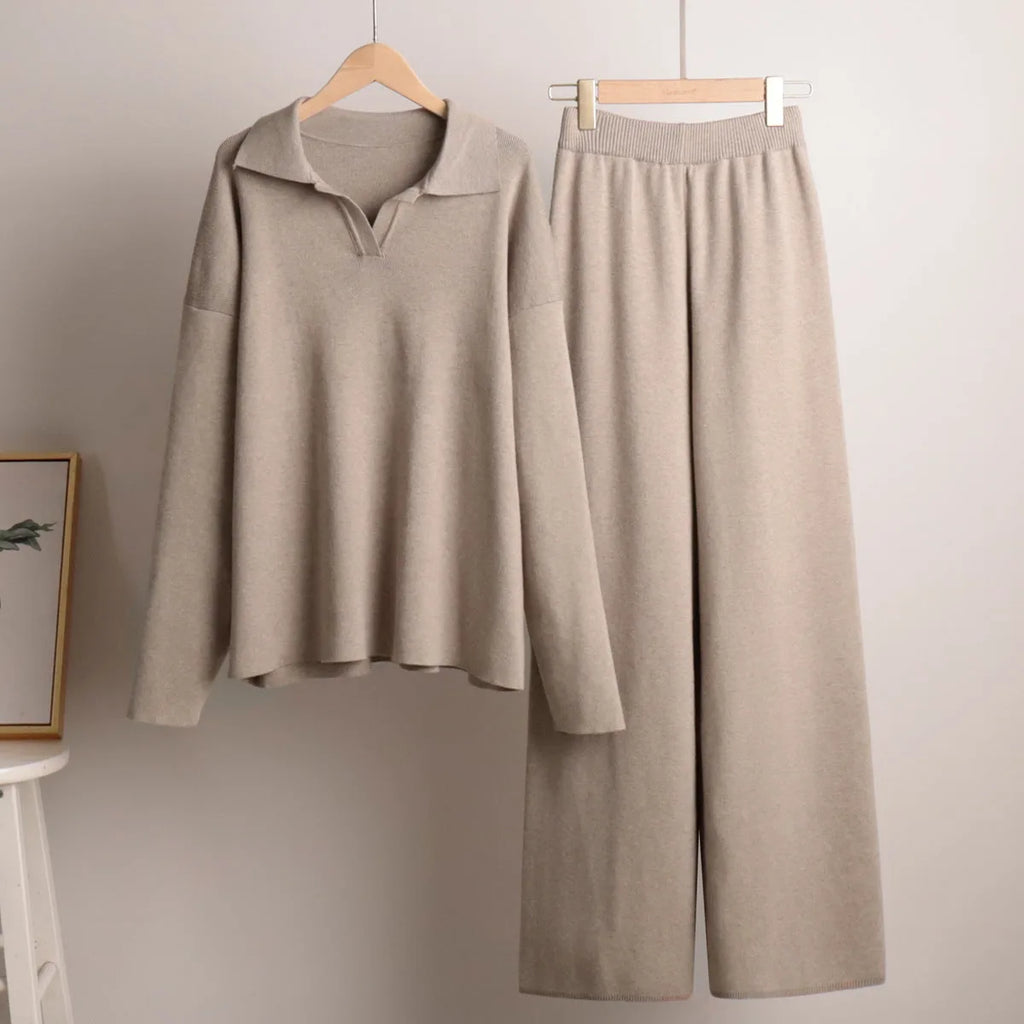 Sand beige polo jumper and matching wide leg knit trousers hanging neatly on wooden hangers