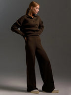 Close view of the ribbed collar and relaxed drop shoulder on the sand coloured knit polo jumper