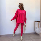 Bright pink oversized sweatshirt and matching leggings paired with a woven tote bag and trainers