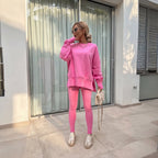 Bubblegum pink oversized sweatshirt and matching leggings worn with a chain necklace and trainers