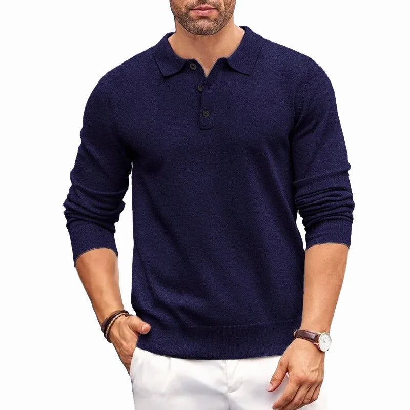 Navy blue knitted polo jumper with ribbed cuffs and three-button collar paired with white trousers