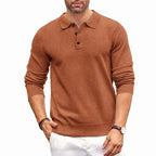 Rust brown knitted polo jumper with collar and button placket worn casually with white trousers