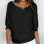 Black flecked knit jumper with wide scoop neckline styled with a layered gold necklace