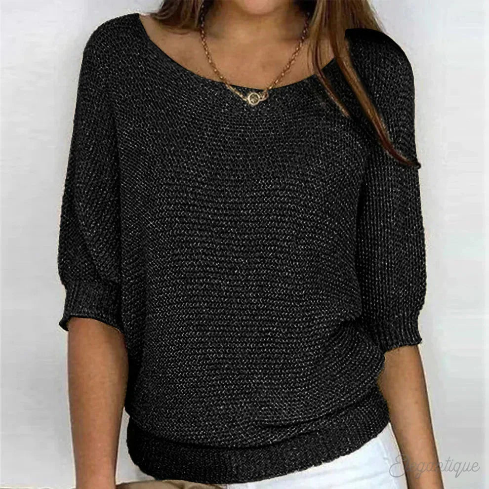 Black flecked knit jumper with wide scoop neckline styled with a layered gold necklace