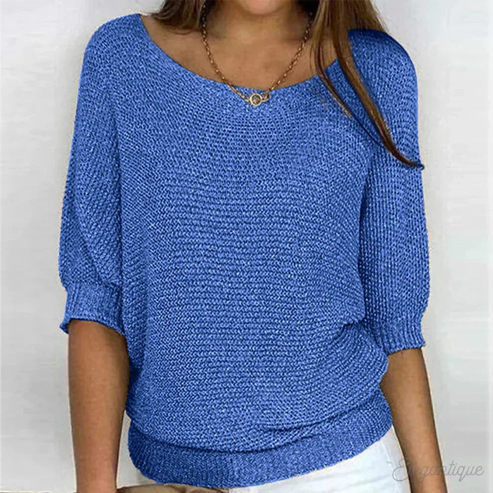 Blue knitted jumper with three-quarter batwing sleeves and fitted ribbed waistband