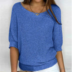 Blue knitted jumper with three-quarter batwing sleeves and fitted ribbed waistband