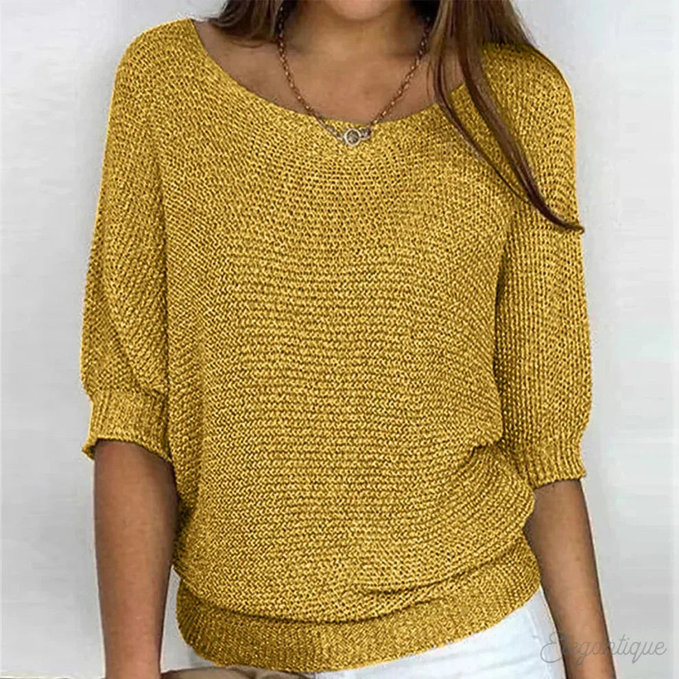 Mustard yellow knit jumper showing the open scoop neck and chunky knit texture