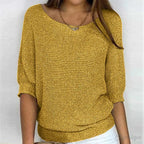 Mustard yellow knit jumper showing the open scoop neck and chunky knit texture