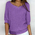 Purple knitted jumper close-up showing off-shoulder style neckline and knit pattern