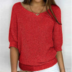 Front view of knitted jumper highlighting the fitted ribbed hem and loose batwing sleeves