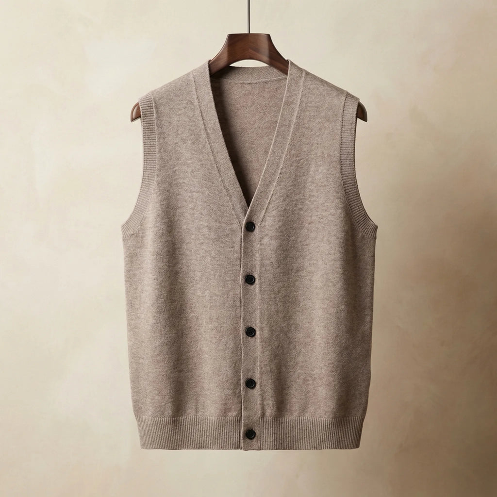Beige knitted waistcoat with V-neck and dark buttons, hanging on a wooden hanger against a neutral backdrop