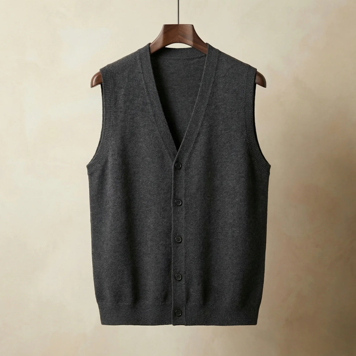 Dark grey knitted waistcoat with full button placket and ribbed armholes, shown hanging straight