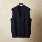 Navy blue knitted waistcoat with V-neck collar and black buttons, hanging on a wooden hanger