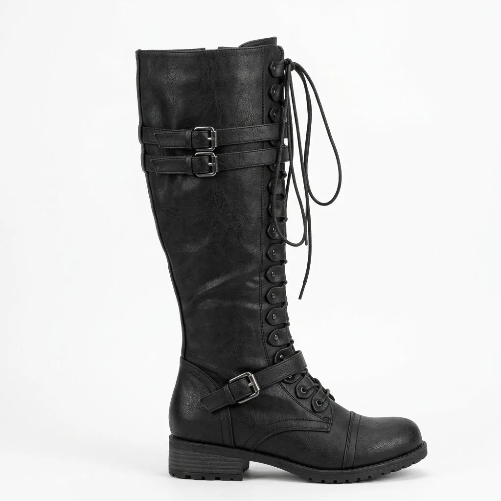 Side view of a black knee-high lace-up combat boot with double buckle straps and lug sole