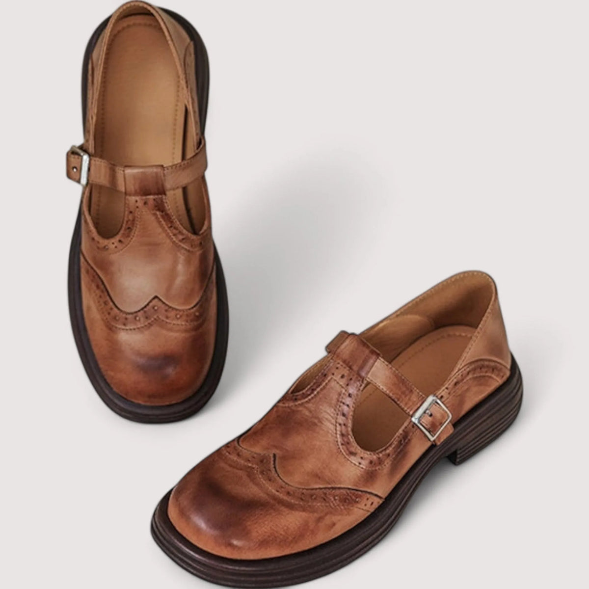 Top and side view of tan brown leather Mary Jane shoes showing the T-strap buckle and stacked dark sole