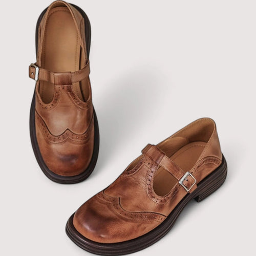 Overhead view of a pair of brown leather Mary Jane brogues showing tan insole and stitched wingtip toe