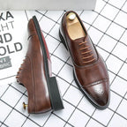 Angled view of brown leather brogue oxford shoes with wooden shoe trees, showing the stitched sole and heel construction