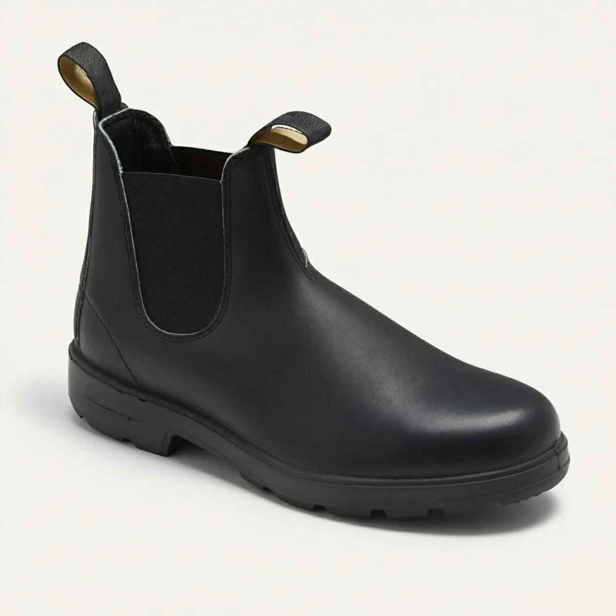 Three-quarter view of a smooth black leather Chelsea boot with elastic panel and pull tabs