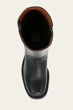 Close-up of the block heel and stacked leather sole on a tan brown leather boot
