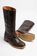 Close-up of the tan leather interior and side zip on a knee-high boot