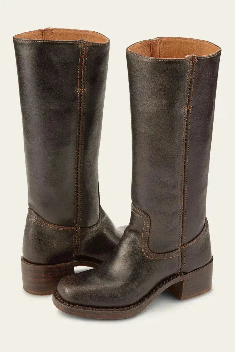 Close-up of the ankle seam and pull tab detail on a tan brown leather boot