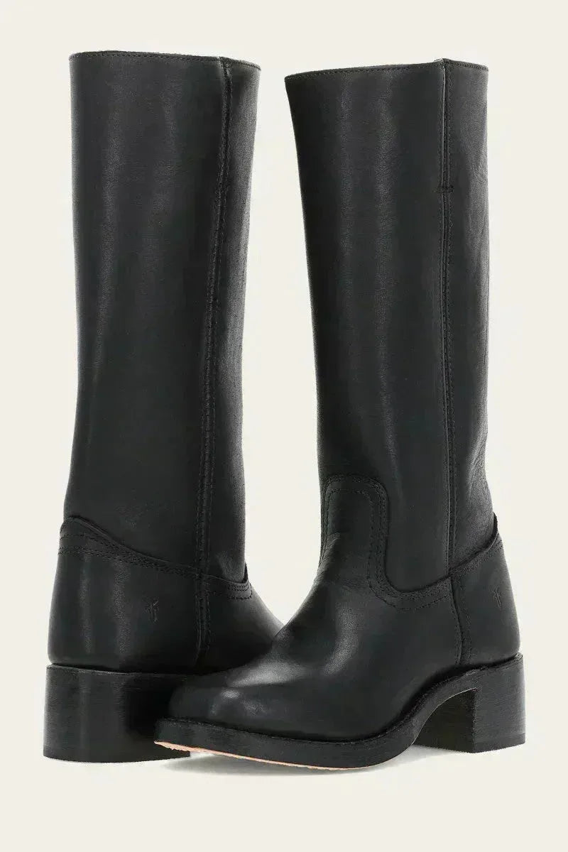 Close-up of stacked wooden block heel and leather sole on a dark brown boot