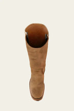 Close-up of the leather grain and vertical seam on a khaki-toned leather boot shaft