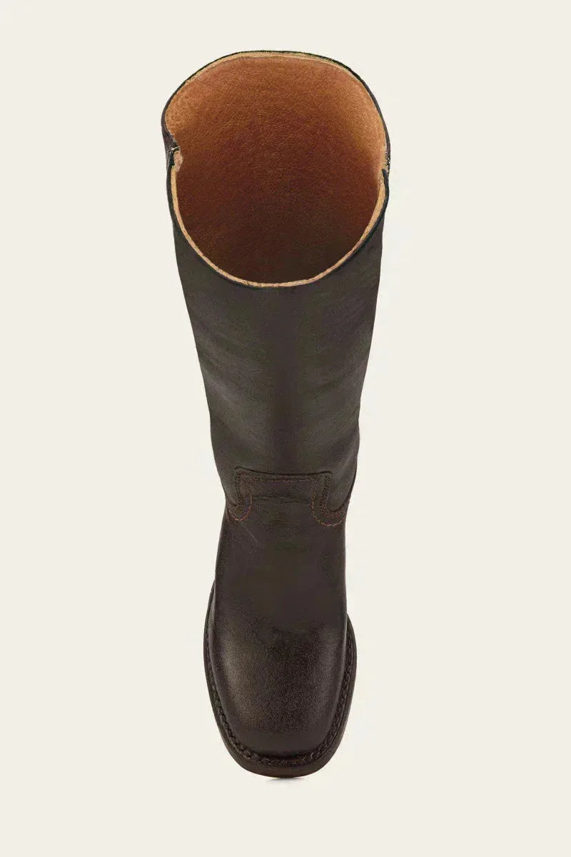 Close-up of the ankle notch detail where the shaft meets the foot on a brown leather boot