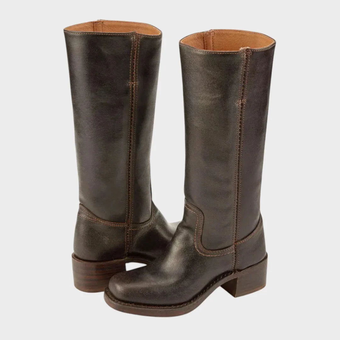 Side-by-side view of knee-high dark brown leather campus boots with stacked wood-tone heels and tan leather lining