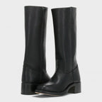 Pair of knee-high black leather campus boots shown at an angle, highlighting the stitched seam detail and block heel
