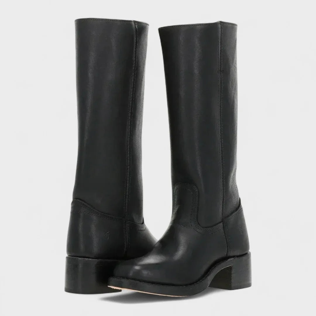 Pair of knee-high black leather campus boots shown at an angle, highlighting the stitched seam detail and block heel