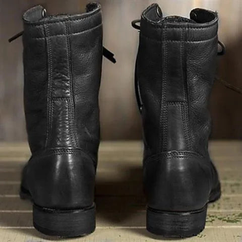 Rear view of black leather lace-up boots showing the seam construction and low tread sole