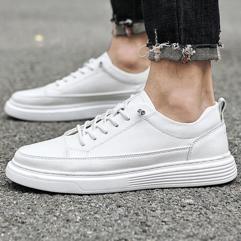 Black leather trainer worn outdoors with cuffed denim jeans and visible ankle