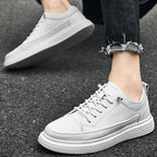 Black leather trainer displayed at an angle showing the full lace-up front and toe shape