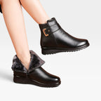 Model wearing black leather ankle boots with one boot folded down to reveal soft grey faux fur lining