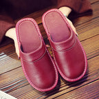Side profile of a brown leather mule slipper showing low heel and cushioned rubber sole