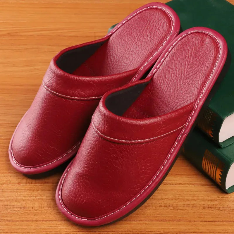 Close-up of white stitched seam detail along the vamp of a brown leather slipper