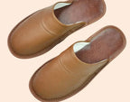 Side angle of brown leather slippers showing the low-profile silhouette and slip-on design