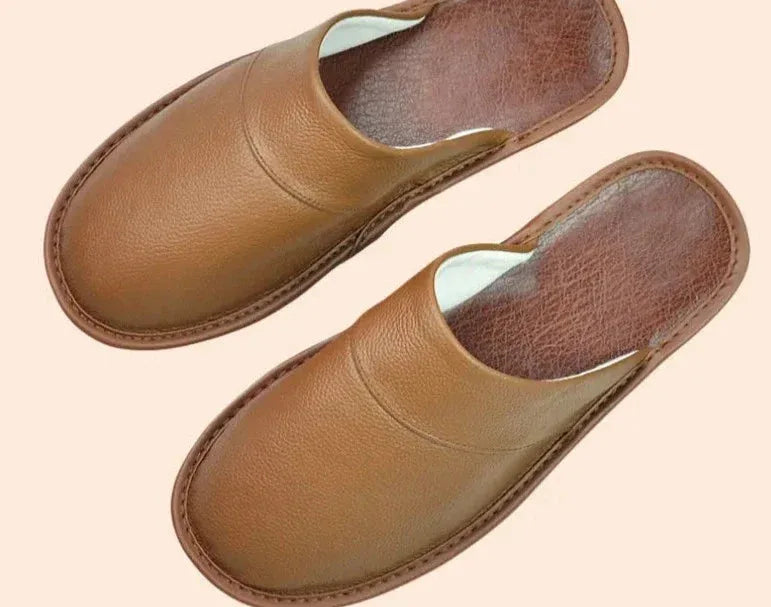 Side angle of brown leather slippers showing the low-profile silhouette and slip-on design