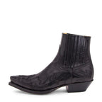 Side view of a black leather ankle boot with pointed toe, flame-stitch western embroidery and elastic side gusset panel