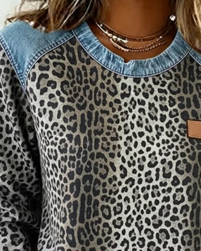 Front view of grey leopard print jumper with denim raglan shoulders and contrast crew neckline