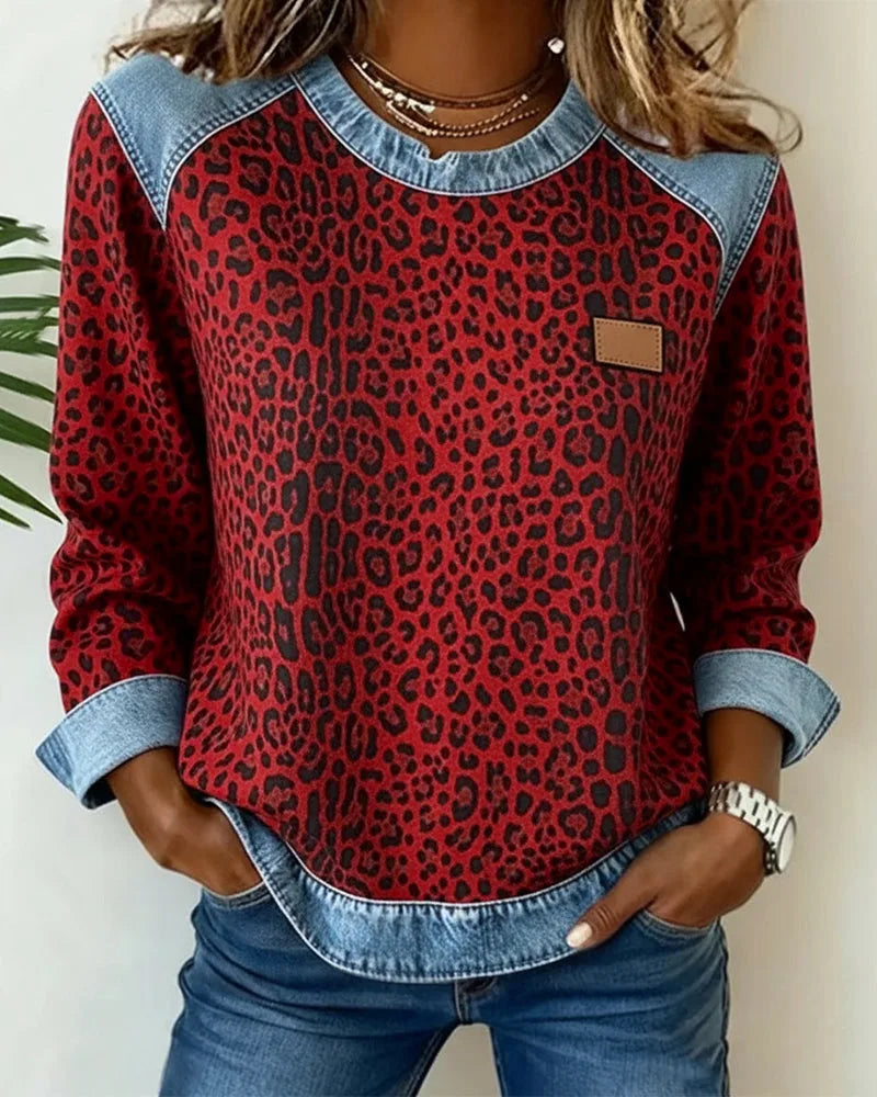 Close-up of grey leopard print hem and folded denim cuff against blue jeans