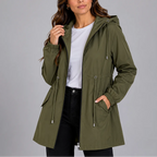 Close view of the olive green hooded rain coat with drawstring hood and adjustable waist toggle, worn open over black jeans.