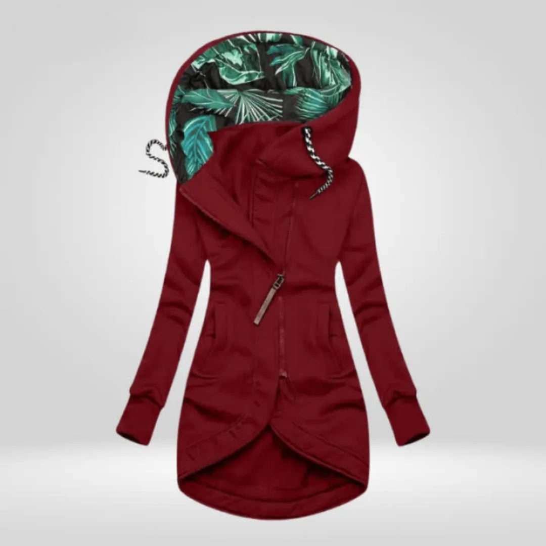 Burgundy asymmetric zip coat with tropical leaf lined hood and striped drawcords