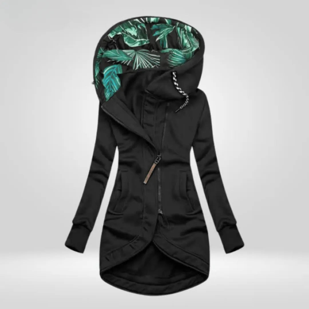 Black longline hooded jacket with tropical leaf print hood interior and curved tulip hem
