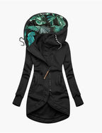 Close-up front angle of black jacket highlighting kangaroo pockets and bronze zip pull