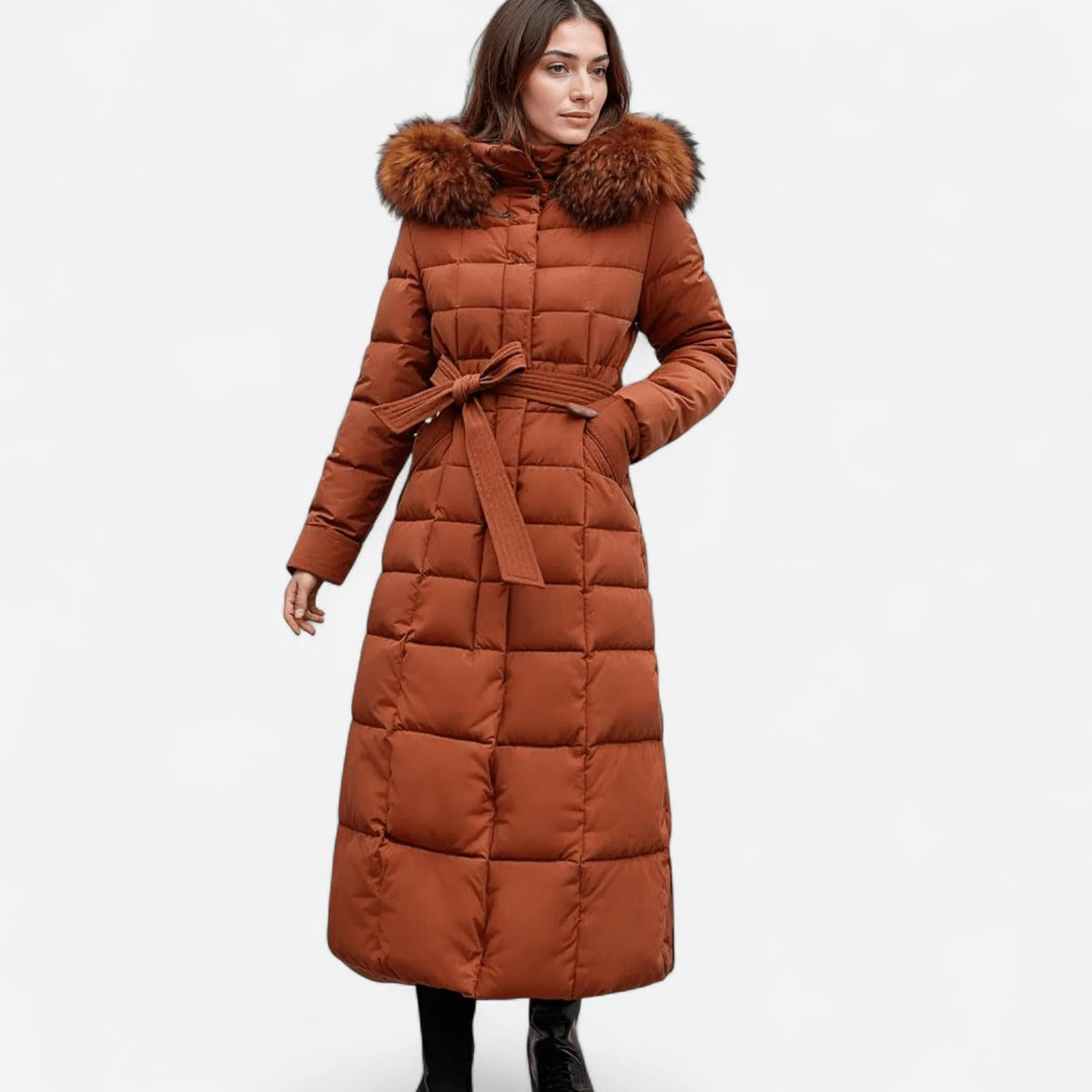 Front view of a caramel maxi puffer coat with a large detachable fur hood and matching tie belt