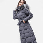 Close-up front view of a dark grey belted puffer coat with a voluminous fur-trimmed hood
