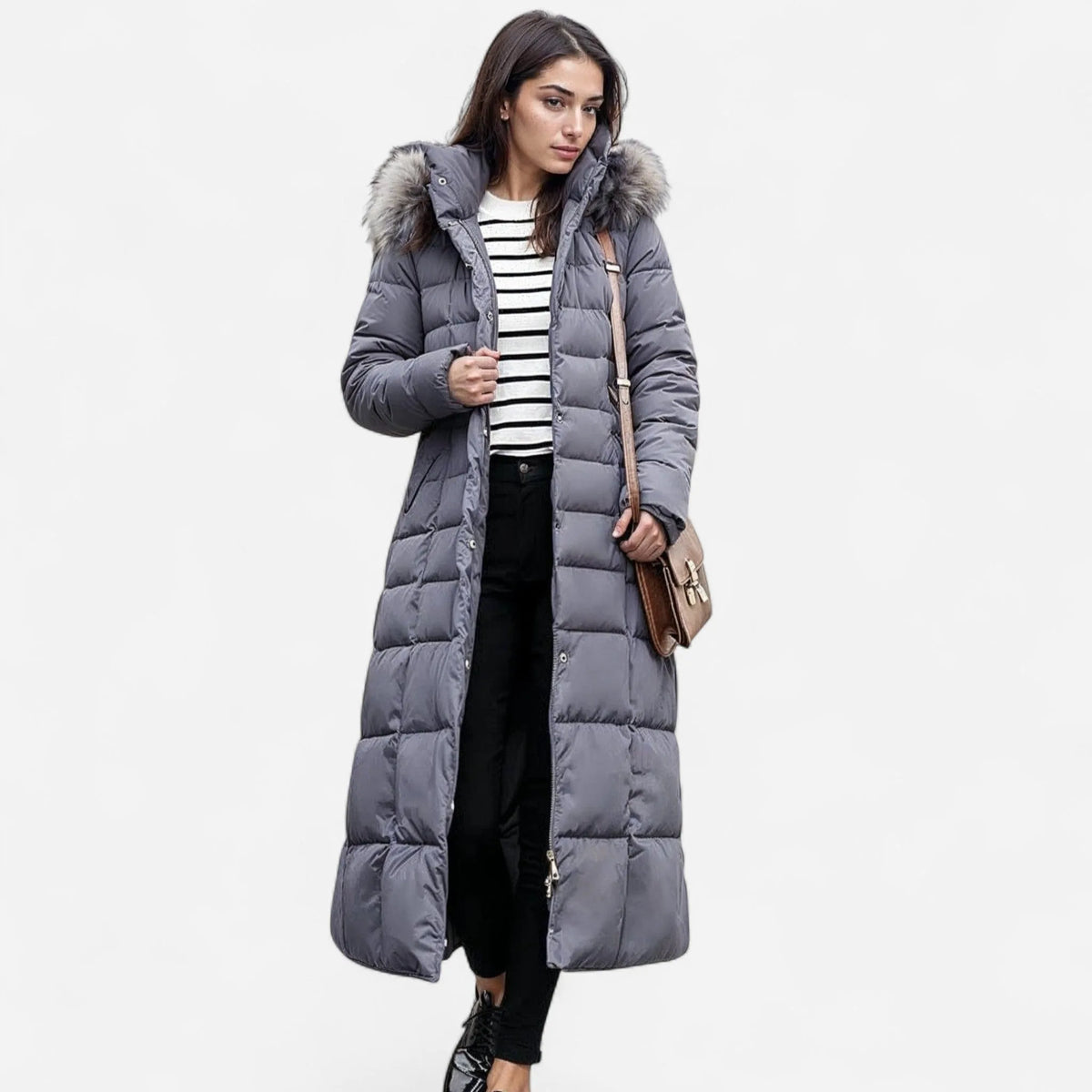 Front view of a grey quilted maxi puffer coat with fur hood, worn open over a striped top
